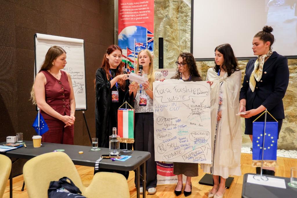 Delegates presenting collaborative policy work during a curated networking session